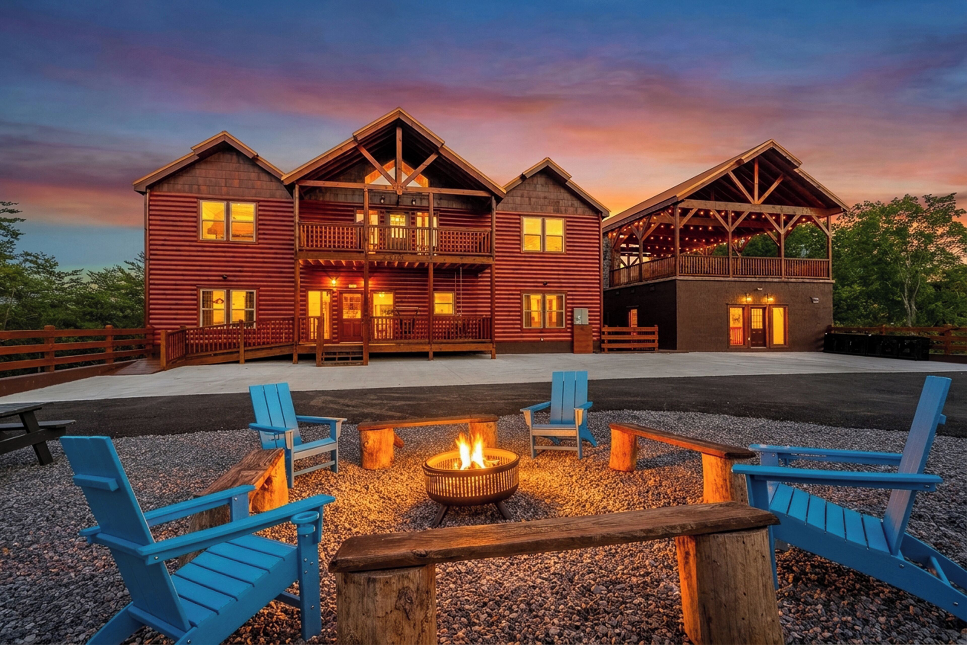 A large, multi-story wooden lodge with a fire pit and outdoor seating.