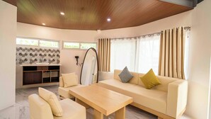 A modern living room with a sofa, a coffee table, and a seating area. - Fizz Diving Resort (Panglao)