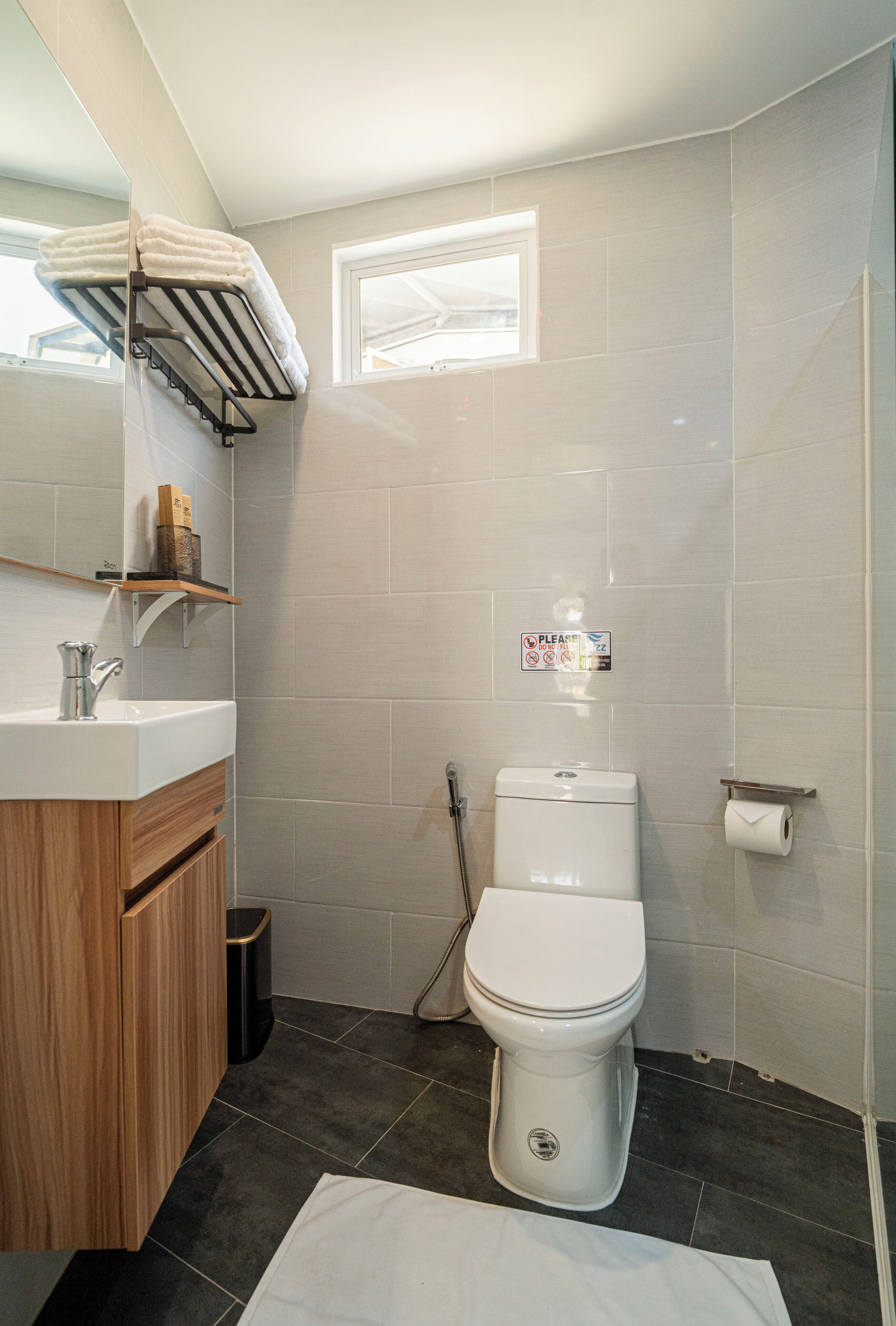 A modern bathroom with a toilet, sink, and shower.