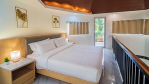 A hotel room with a bed, nightstand, and a view of the outdoors. - Fizz Diving Resort (Panglao)