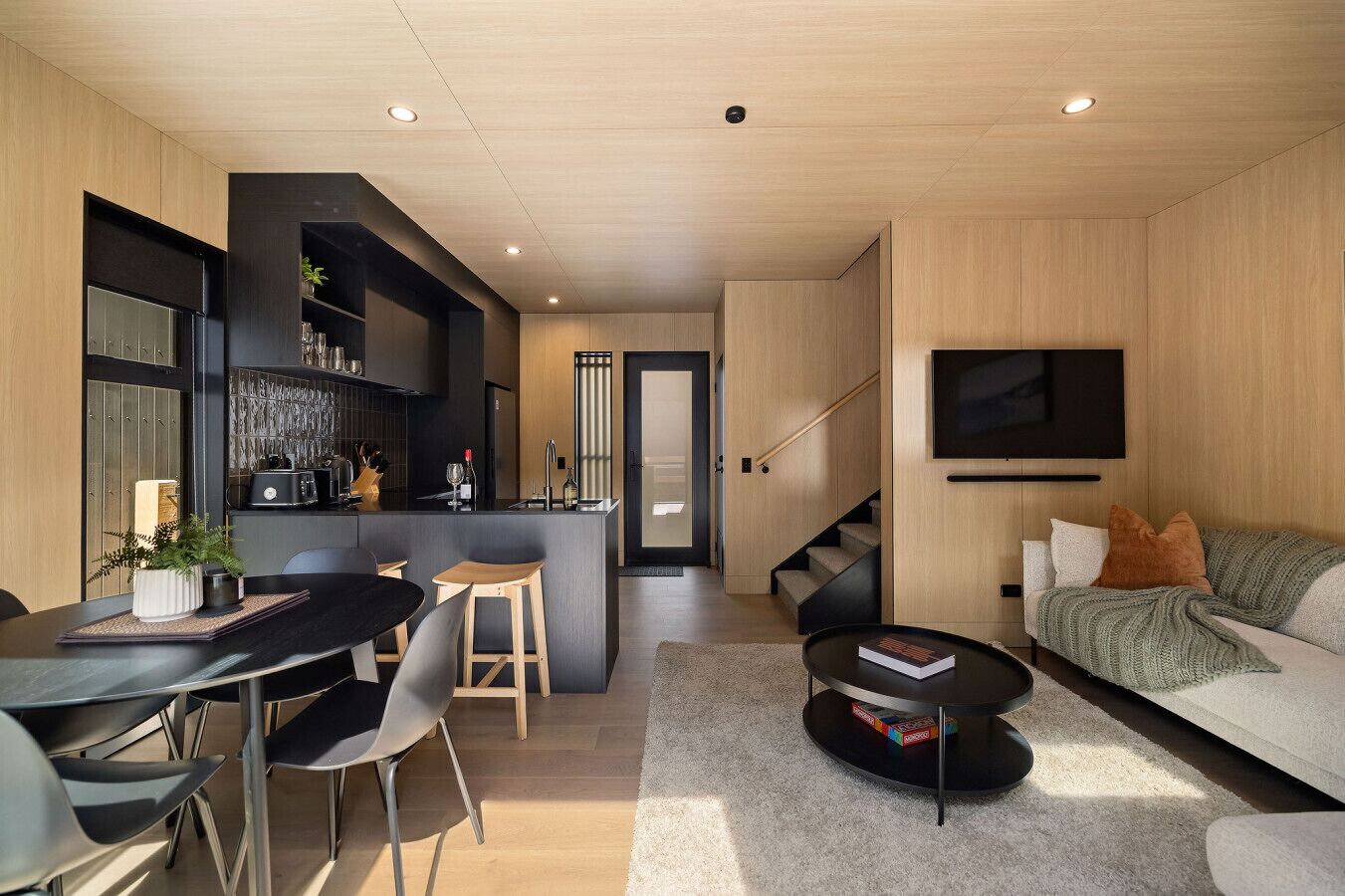 A modern interior with a dining area, kitchen, and living space.
