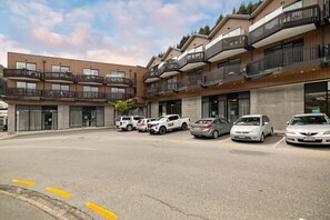 A modern multi-story building with balconies, parked cars, and a clear sky. - Prime Location, Walk to town, Queenstown (Queenstown)