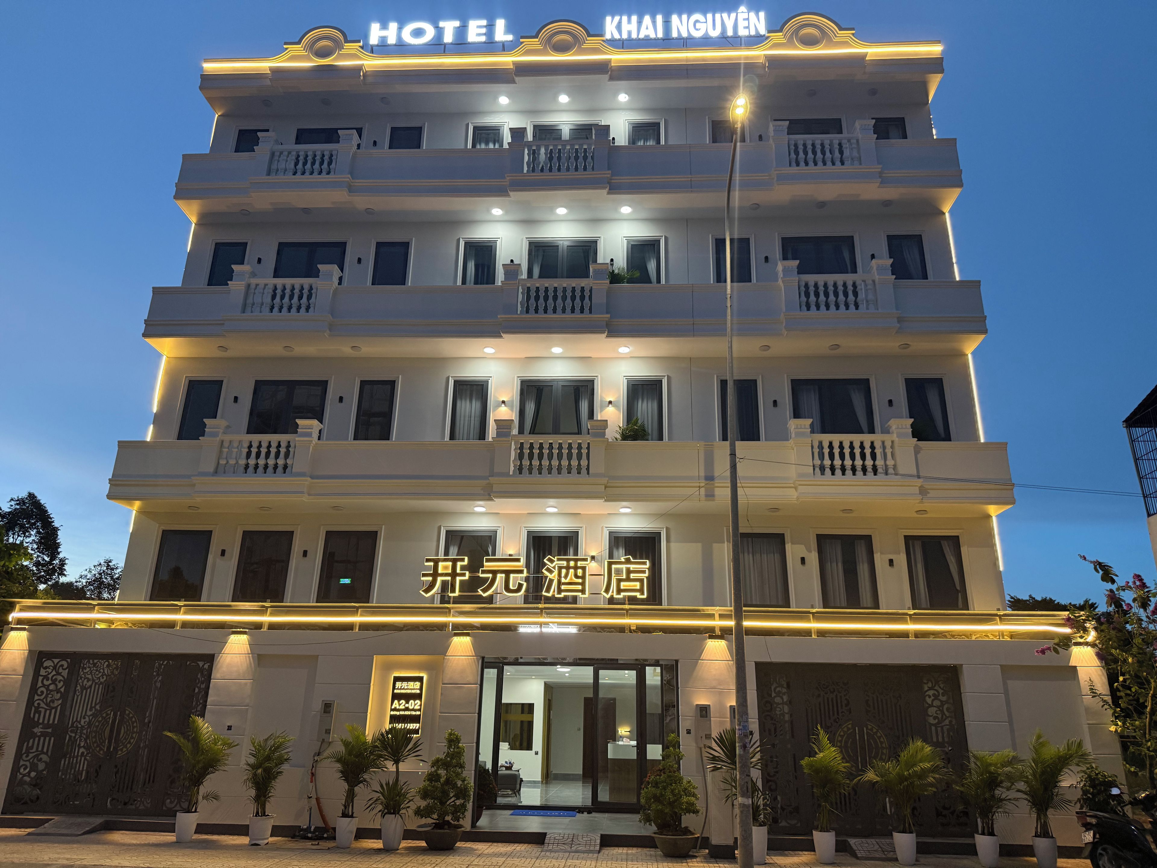 A multi-story hotel with a prominent sign indicating it is the 'KHAI NGUYEN HOTEL.'
