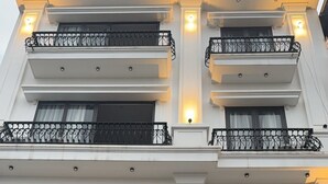 Fachada de hotel con un cartel que dice 'NAINGUYEN HOTEL' y el número '104' indicando la dirección del edificio.
