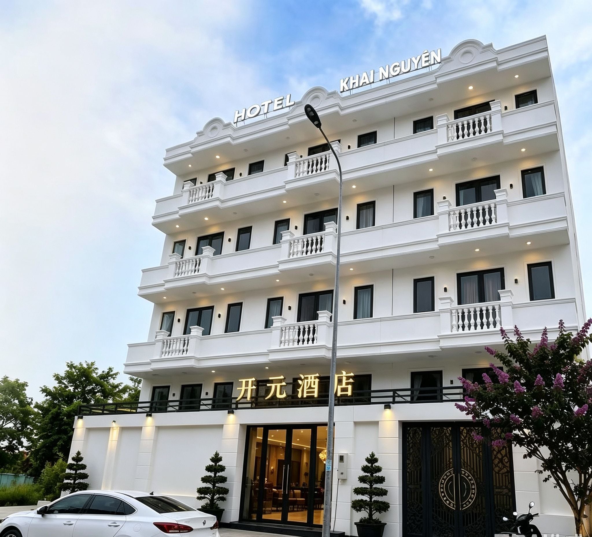 A multi-story hotel with a prominent sign reading 'KHAI NGUYEN HOTEL' at the top.