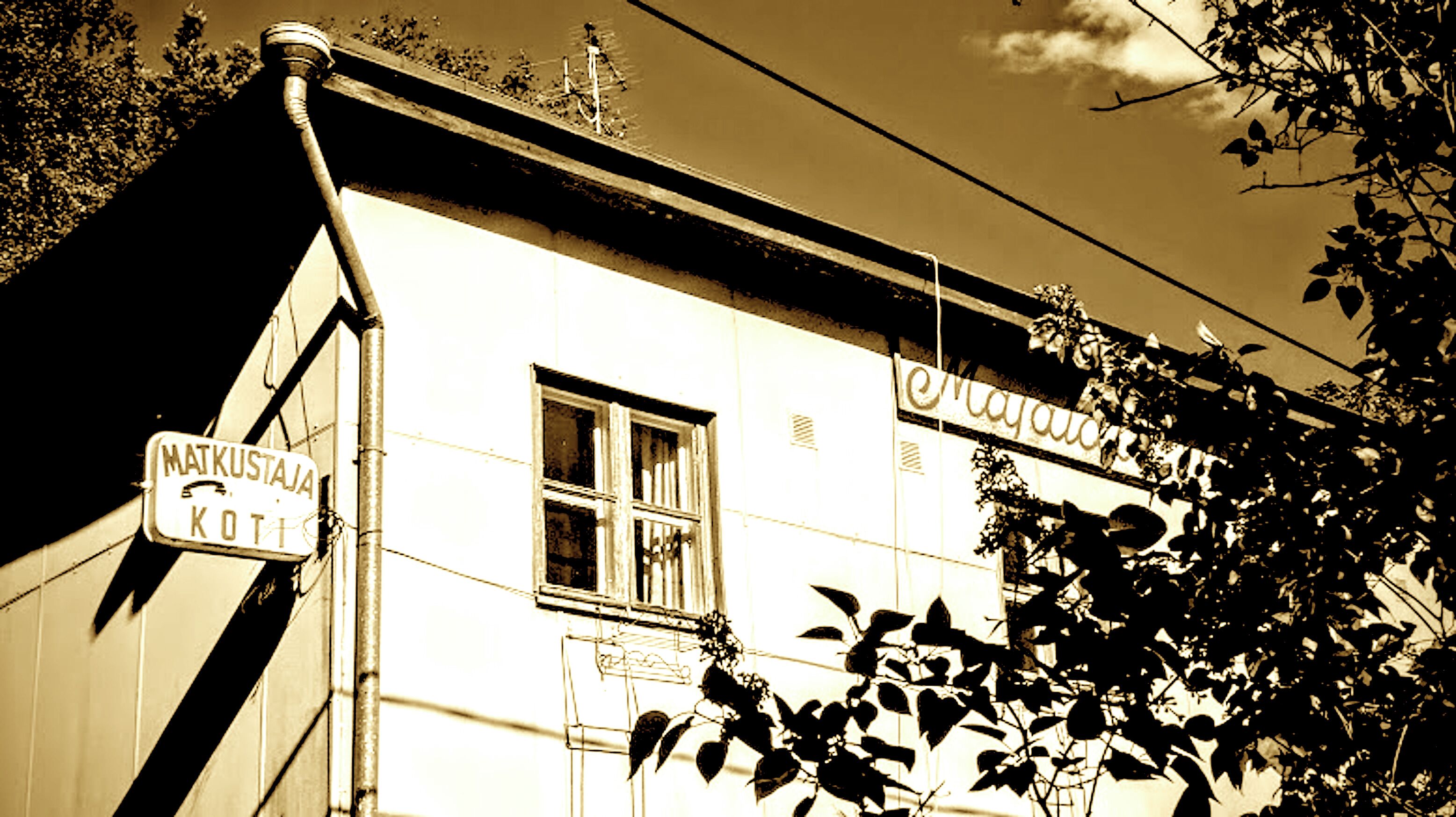A building with a sign reading 'MAJKUSTAJA KOTI' and another sign above it.