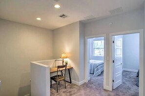 A bedroom with a bed, a desk with a chair, and a window. - Modern Farmhouse Mesa Retreat (Mesa)