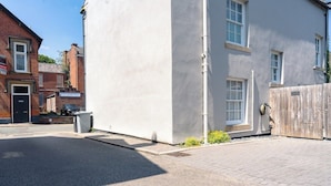 A residential building with a garage, a paved driveway, and a small garden area. - St James House Timeless Comfort Central Congleton (Congleton)
