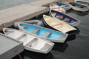 A wooden dock with several small boats tied up.