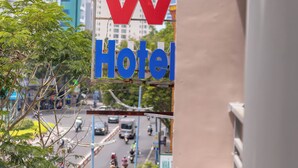 A hotel sign with the name 'NEW Hotel' in red and blue letters. - New Hotel Vung Tau (Ho Chi Minh City)