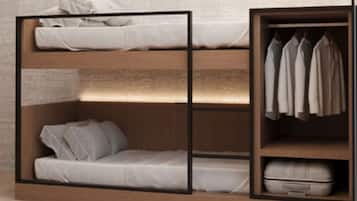 A bunk bed with a wardrobe and a shelf unit.