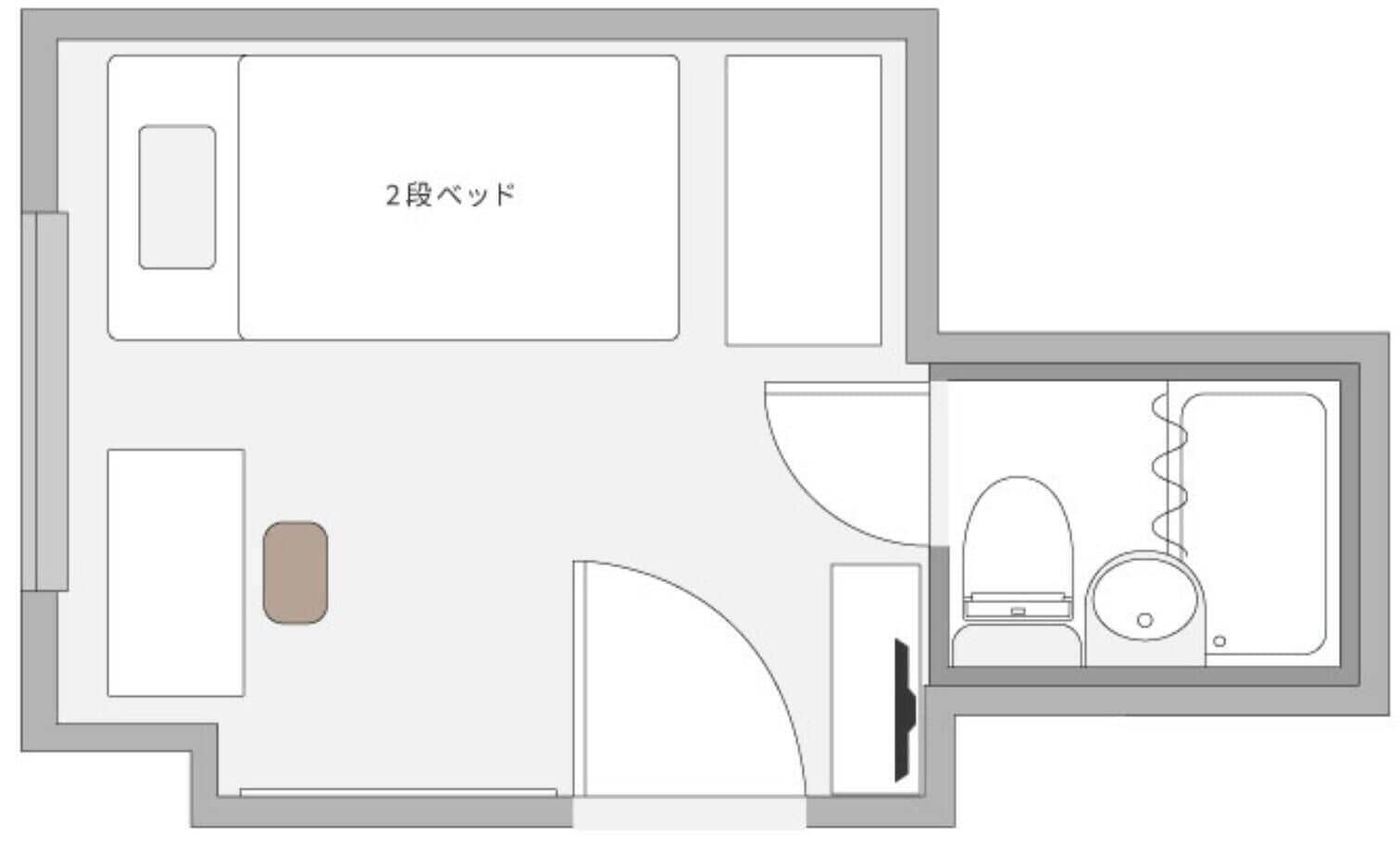 A floor plan with a bathroom, a kitchenette, and a living area.