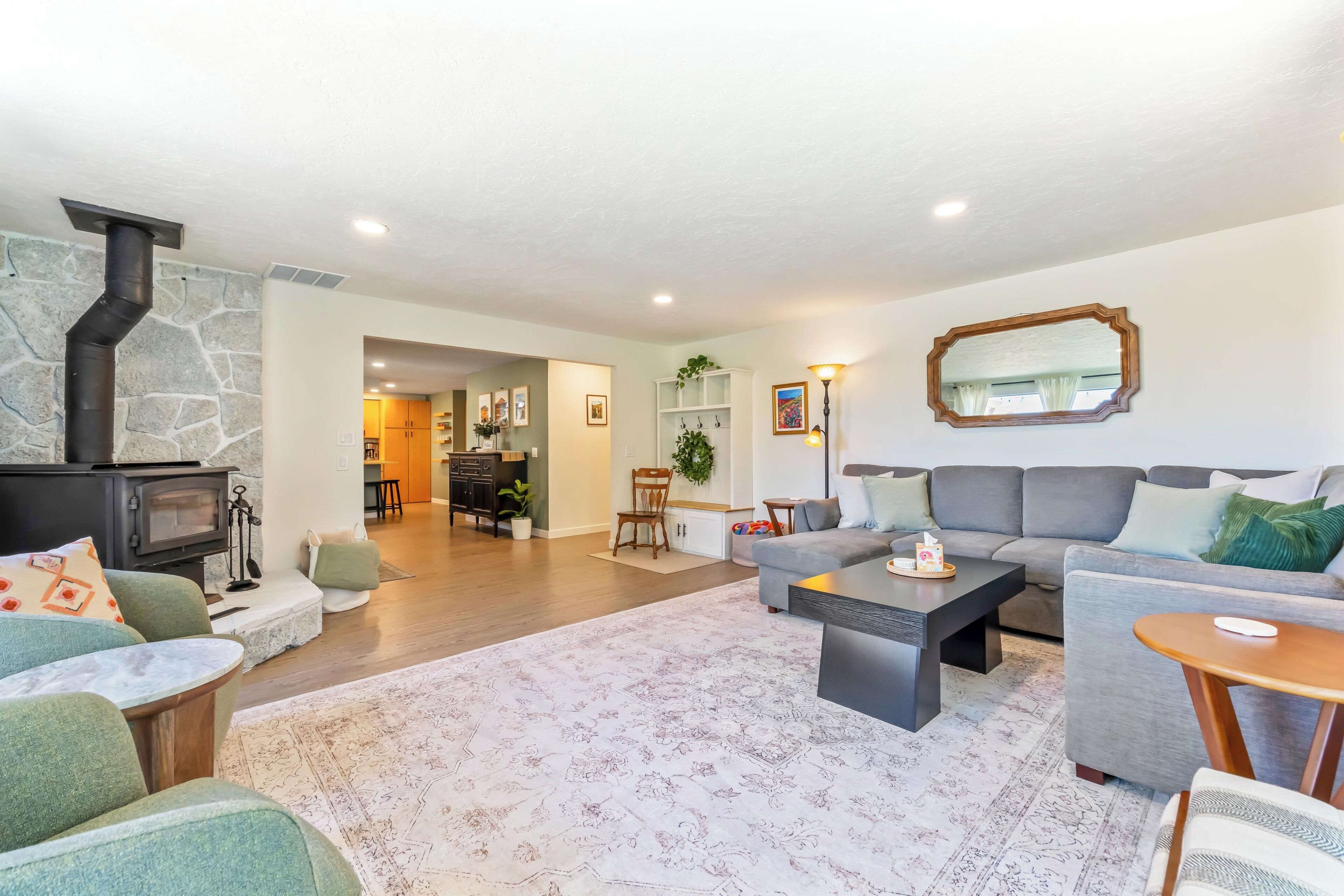 A modern living room with a fireplace, sofa, and coffee table.