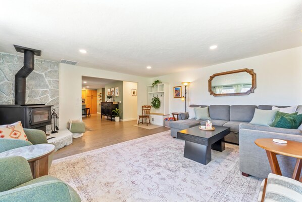 A modern living room with a fireplace, sofa, and coffee table.