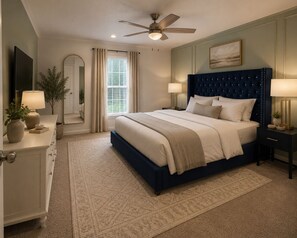 A bedroom with a bed, nightstands, a ceiling fan, a window with curtains, and a mirror. - Luxury Oak Escape l Hot
Tub & Nature &Game Room (Bulverde)