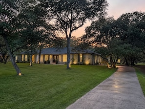 A house with a paved driveway and a lawn.