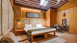 A wooden room with a bed, a desk, and a chair. - Palette Irayos Resort Palghar (Dahanu)
