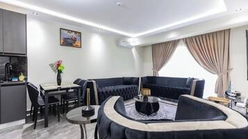 Deluxe Apartment, City View | Living area | Smart TV