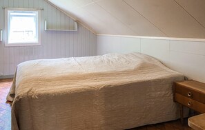 A bedroom with a bed, a window, and a wooden nightstand. - 5 bedroom lovely home in Syvde (Syvde)
