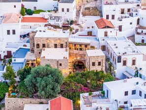 A densely packed urban area with white buildings, some with red-tiled roofs, and a central stone building with an archway. - Vasilikos Mansion by Interhome (Pefki)