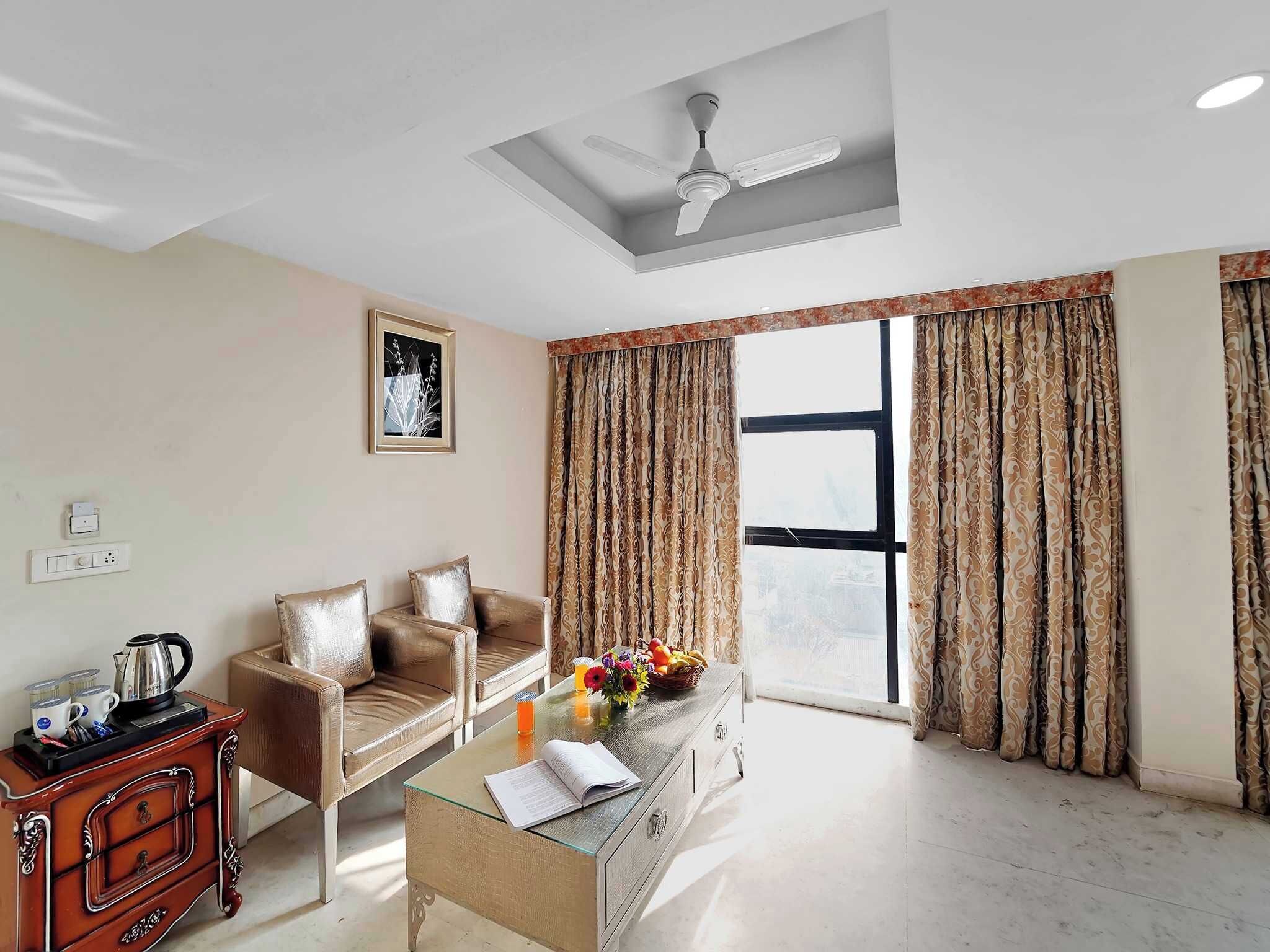 A modern living room with a sofa, coffee table, and a ceiling fan.