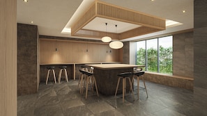 A modern kitchen with a central island, bar stools, and a large window offering a view of greenery. - Minn Osaka Namba Station (Osaka)