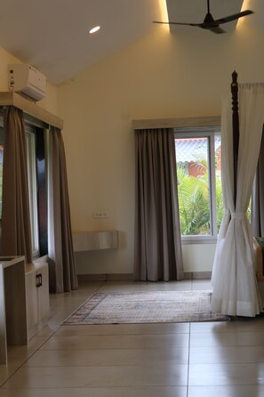A room with a ceiling fan, a window with curtains, a built-in sink, and a tiled floor. - The Divine Valley By Devandhari (Sakleshpur)