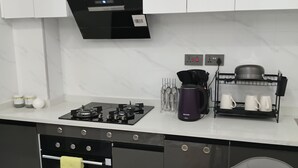 Eine moderne Küche mit Gasherd, Backofen und Kaffeemaschine.