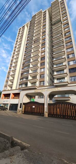 A high-rise building with multiple balconies and a gated entrance. - Modern cozy Retreat (Nairobi)