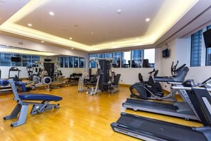 A gym with treadmills, weight machines, and a mirrored wall. - Aesthetic Four-Level 4 Bedroom l near Marina Walk (Dubai Marina)