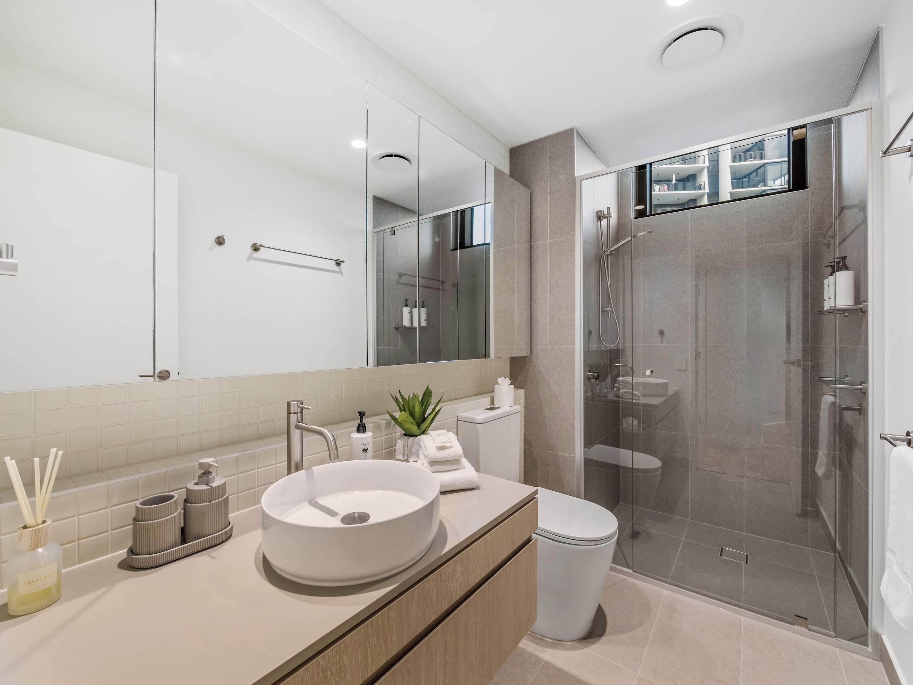 Second bathroom, walk-in shower and a stone-topped vanity.