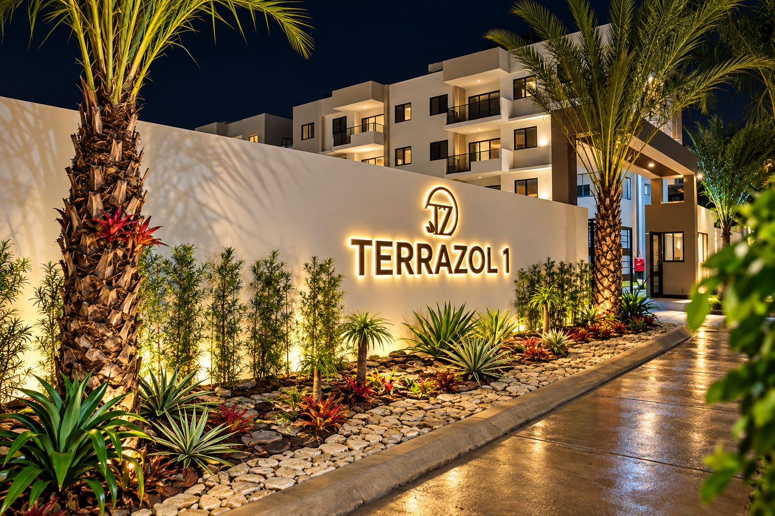 A modern hotel entrance with a sign reading 'TERRAZOL 1' and a pathway lined with tropical plants.