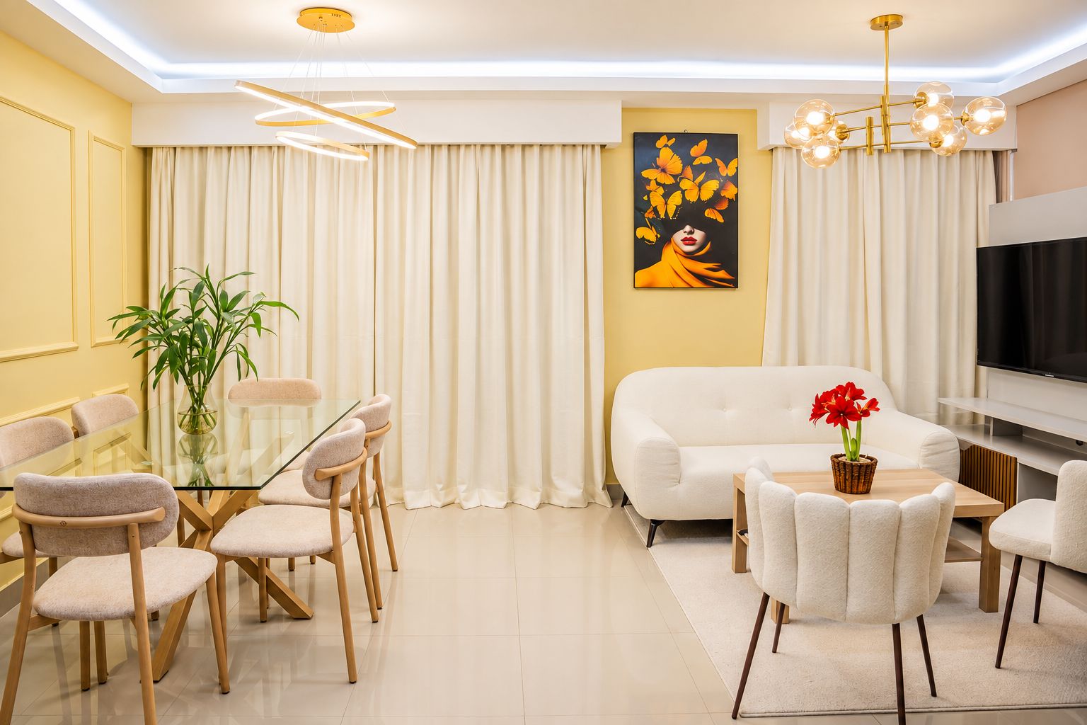 A modern living room with a dining area, a sofa, a TV, and a painting on the wall.
