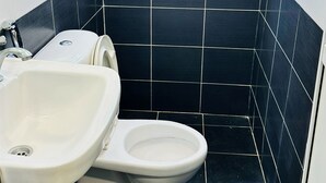 A bathroom with a toilet, bidet, and sink. - Hotel Taming Sari 707 (Malacca City)