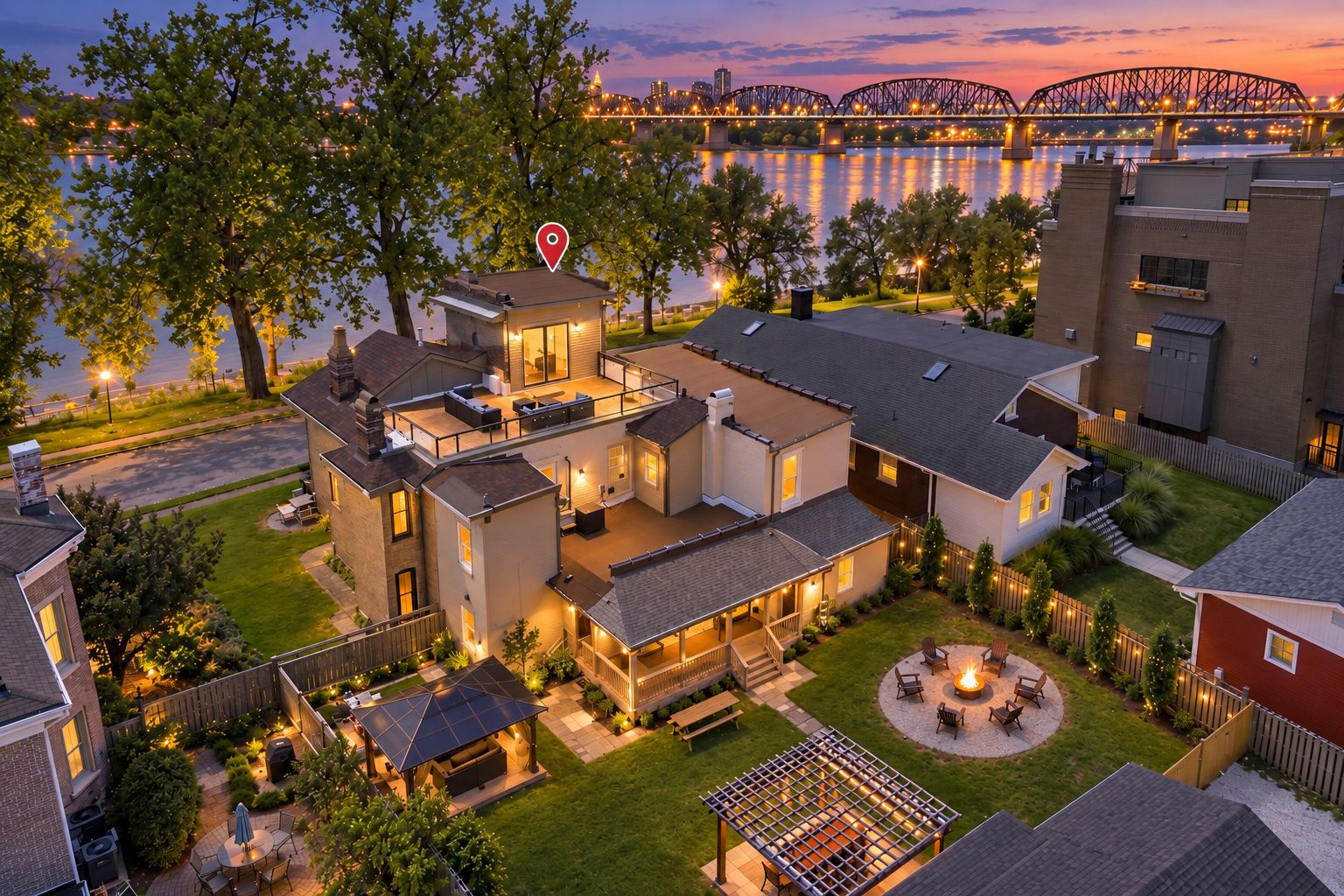 A residential property with a large patio, outdoor seating, and a view of a bridge.