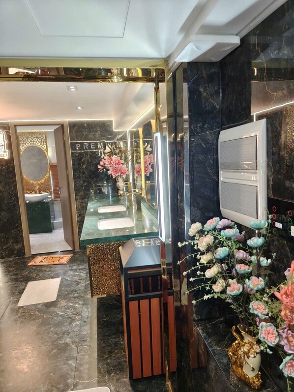 A modern bathroom with a glass shower enclosure, marble countertops, and a vanity with a mirror.