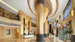A spacious lobby with high ceilings, large columns, and a reception desk. - Shunhui Century Baden Hotel (Mianyang)