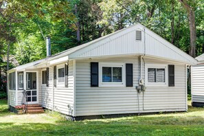 A single-story house with a front porch, a chimney, and a garage.