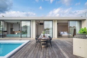 A modern outdoor dining area with a pool, a bedroom, and a living space. - Predmet Cascade Bali (Tabanan)