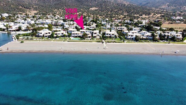 An aerial view of a coastal residential area with houses, a beach, and clear blue waters. - Cosy Garden Flat, Beach, Pool – Mountain View, Private Pool, Air Conditioning (Akti Idras)