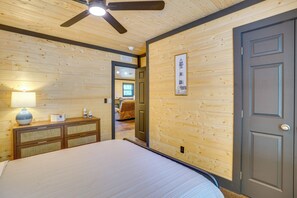 A bedroom with a bed, a dresser, a lamp, and a ceiling fan. - Family & Pet Friendly! Murray Cabin w/ Lake Access (Murray)