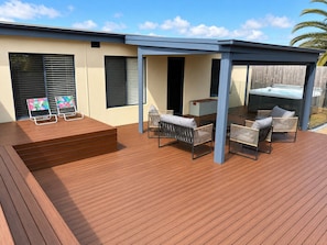 A wooden deck with outdoor furniture, a hot tub, and a covered seating area. - Solander in Dromana with Private Spa (Dromana)