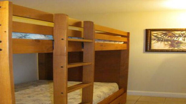 A bunk bed with a ladder, a mattress, and a framed picture on the wall. - Disney dreams Penthouse water view Mall restaurant (Orlando)