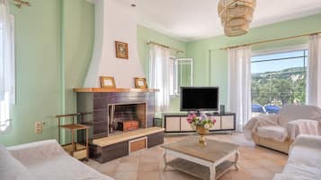 A living room with a fireplace, television, and seating area.