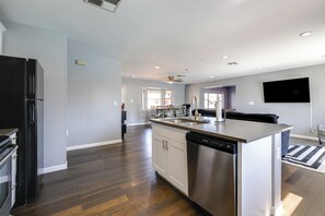A modern kitchen with a central island, built-in appliances, and a view to the living area. - Desert Retreat w/ Pool Near Dtwn Tempe & ASU (Tempe)