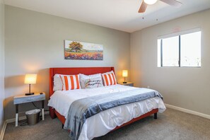 A bedroom with a bed, two bedside tables, a nightstand, a painting, and a window. - Desert Retreat w/ Pool Near Dtwn Tempe & ASU (Tempe)