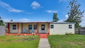 A single-story house with a porch, a small table, and two chairs. - On Deer Point Lake! Home w/ Private Dock & Hot Tub (Youngstown)
