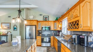 A spacious kitchen with wooden cabinets, stainless steel appliances, and a granite countertop. - 1 1/2 Blocks to Beach! Close to A/C, Casinos (Brigantine)