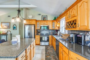 A spacious kitchen with wooden cabinets, stainless steel appliances, and a granite countertop. - 1 1/2 Blocks to Beach! Close to A/C, Casinos (Brigantine)