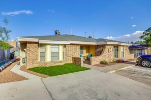 A residential house with a brick facade, a front lawn, and a garage. - Shop, Dine & Explore: El Paso Escape w/ Patio (El Paso)